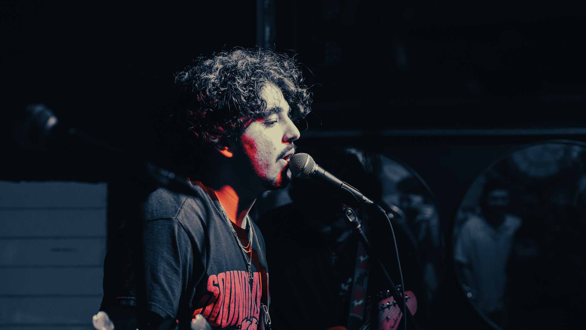 Singer and guitarist performing at a microphone